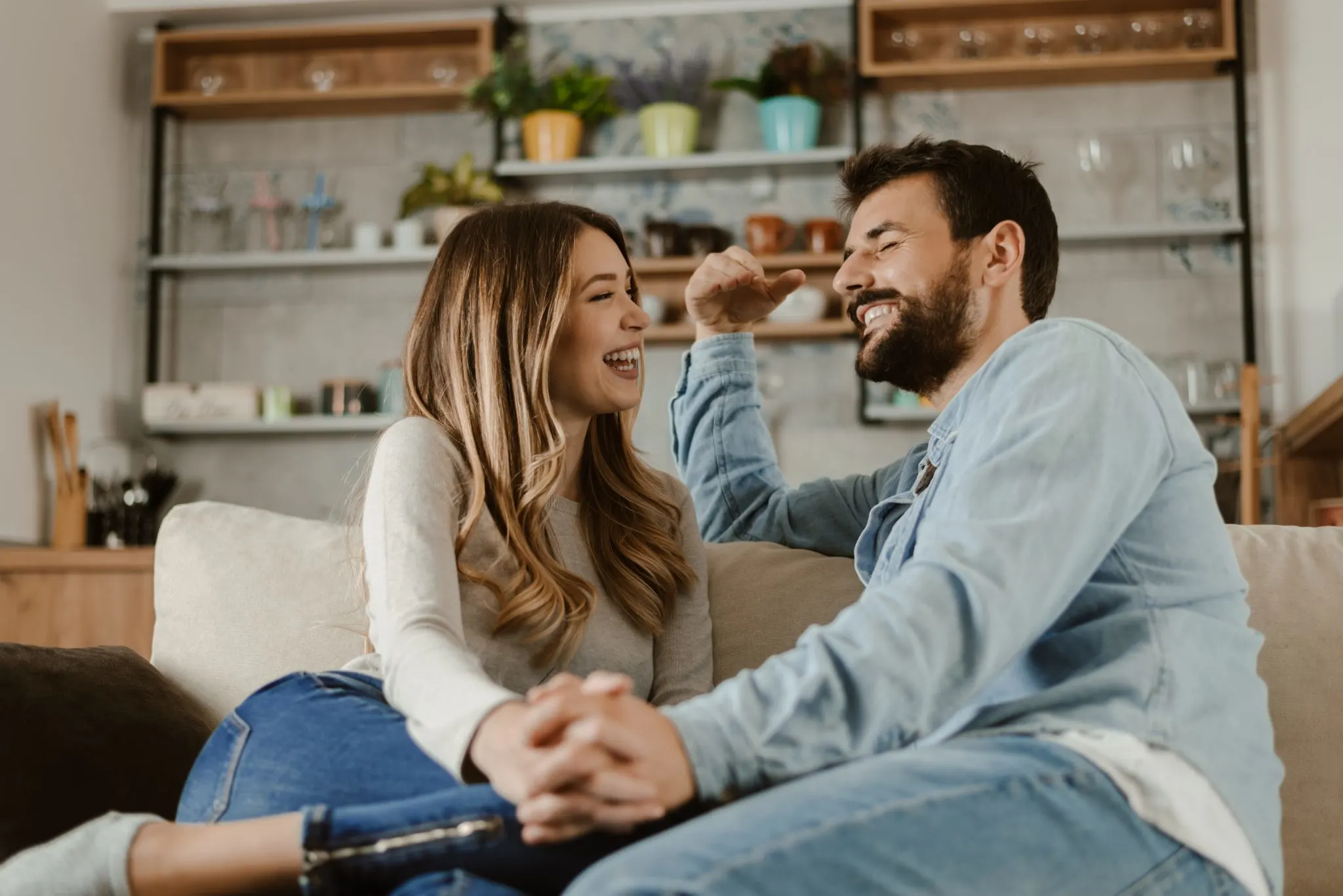 Smiling couple sitting on a sofa and chatting together in a cozy living room